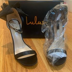 Never-worn black high heels with bow detail